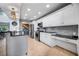 Bright kitchen with white cabinetry, stainless steel appliances, and a view of the staircase at 9011 Baywood Park Dr, Seminole, FL 33777