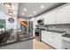 Kitchen boasting granite countertops, stainless steel appliances, gray subway tile, and classic white cabinetry at 9011 Baywood Park Dr, Seminole, FL 33777