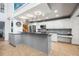 Kitchen showcasing stylish pendant lighting, sleek countertops, stainless steel appliances, and white cabinetry at 9011 Baywood Park Dr, Seminole, FL 33777