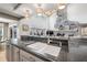 Kitchen area with granite countertops, a double sink, and a view of the stone fireplace in the living room at 9011 Baywood Park Dr, Seminole, FL 33777