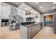 Open concept kitchen with a view of the stone fireplace and living room at 9011 Baywood Park Dr, Seminole, FL 33777