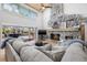 Inviting living room featuring a stone fireplace, vaulted ceilings, and sliding glass doors to the outdoor living area at 9011 Baywood Park Dr, Seminole, FL 33777