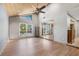 Open-concept living room with wood floors, vaulted ceilings, and expansive windows at 9011 Baywood Park Dr, Seminole, FL 33777