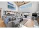 Open-concept living room with vaulted ceilings, tile floors, and a seamless connection to the outdoor dining space at 9011 Baywood Park Dr, Seminole, FL 33777