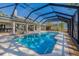 A spacious screened-in pool with an attached patio featuring open access to the main house at 9011 Baywood Park Dr, Seminole, FL 33777
