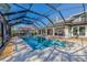 Enclosed pool area featuring a large pool, open-air lounging, and a glimpse of the home's architecture at 9011 Baywood Park Dr, Seminole, FL 33777