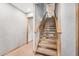 A carpeted staircase with a wood banister and natural light coming through a window at 9011 Baywood Park Dr, Seminole, FL 33777