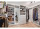 Spacious walk-in closet with custom shelving and ample storage space for shoes, clothing, and accessories at 9011 Baywood Park Dr, Seminole, FL 33777