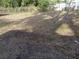 This overgrown backyard with debris and patchy grass requires maintenance at 902 Marshall St, Clearwater, FL 33755