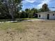View of the property's backyard and auxiliary structure with large paved section at 902 Marshall St, Clearwater, FL 33755
