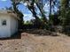 This backyard has a partial fence, sparse vegetation, and surrounding greenery at 902 Marshall St, Clearwater, FL 33755
