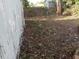 Overgrown backyard with debris and dead leaves at 902 Marshall St, Clearwater, FL 33755
