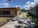 View of a long driveway leading to a property with an adjacent yard and foliage, taken on a sunny day at 902 Marshall St, Clearwater, FL 33755