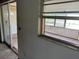 View from living room to enclosed porch featuring jalousie windows and view to the outside at 902 Marshall St, Clearwater, FL 33755