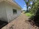 Exterior shot of home with peeling paint and yard covered with dried leaves at 902 Marshall St, Clearwater, FL 33755