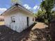 Exterior view of a home featuring peeling paint, an adjacent lot, and a broken window at 902 Marshall St, Clearwater, FL 33755