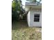 Exterior view of a dilapidated building with peeling paint and overgrown vegetation at 902 Marshall St, Clearwater, FL 33755