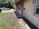 Close up view of the side of the home with brick and painted walls, with car in driveway at 902 Marshall St, Clearwater, FL 33755