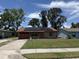 Charming single-story brick home with solar panels, a one-car garage and a well-maintained lawn at 902 Marshall St, Clearwater, FL 33755