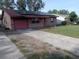 Charming single-story brick home featuring a driveway and solar panels on the roof at 902 Marshall St, Clearwater, FL 33755