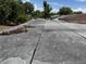 Wide shot of the flat roof with a dark membrane, showing dirt, debris, and wear from surrounding foliage at 902 Marshall St, Clearwater, FL 33755