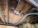 Garage ceiling with exposed beams and damaged plywood, indicative of water intrusion and deterioration at 902 Marshall St, Clearwater, FL 33755