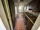 View of the kitchen with tile flooring, dark wood cabinetry, and signs of wear and tear at 902 Marshall St, Clearwater, FL 33755