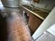 Dark wood kitchen with stainless steel sink, and tile floors showing visible signs of wear at 902 Marshall St, Clearwater, FL 33755