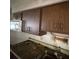 The kitchen area features dark wood cabinets and dated appliances, requiring renovation at 902 Marshall St, Clearwater, FL 33755