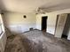 Spacious living room features a ceiling fan and doorway with visible signs of wear and tear at 902 Marshall St, Clearwater, FL 33755