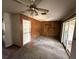 Living room features front door, wood paneled walls, sliding glass door and ceiling fan at 902 Marshall St, Clearwater, FL 33755