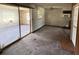 Living room features sliding glass doors, view to kitchen, and ceiling fan at 902 Marshall St, Clearwater, FL 33755
