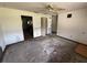 Open living room space features ceiling fan and doorway with visible signs of wear and tear at 902 Marshall St, Clearwater, FL 33755