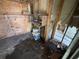 Bare room with wood-paneled walls, plywood, and exposed utilities at 902 Marshall St, Clearwater, FL 33755