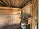 Bare room with wood-paneled walls, plywood, exposed utilities, and storage at 902 Marshall St, Clearwater, FL 33755