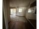 View of a room with sliding glass doors, ceiling fan and wear and tear visible at 902 Marshall St, Clearwater, FL 33755