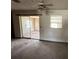 View of a room with sliding glass doors, ceiling fan, and wear and tear visible at 902 Marshall St, Clearwater, FL 33755