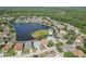 Aerial view of neighborhood featuring lake and multiple single-Gathering homes at 10435 Deerberry Dr, Land O Lakes, FL 34638