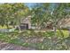 Aerial view of the backyard featuring covered porch and screened-in porch at 10435 Deerberry Dr, Land O Lakes, FL 34638