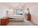 Inviting bedroom with a soft pink color scheme, a comfortable bed, and a sliding glass door at 10435 Deerberry Dr, Land O Lakes, FL 34638
