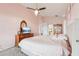 Lovely bedroom featuring a comfortable bed, elegant dresser, and soft pink walls with accent decor at 10435 Deerberry Dr, Land O Lakes, FL 34638
