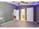 Gray carpeted bedroom featuring LED accent lighting, multiple closets, and open entry to bathroom at 10435 Deerberry Dr, Land O Lakes, FL 34638