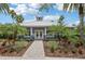 Exterior of the community clubhouse with palm trees and stone-paved walkway at 10435 Deerberry Dr, Land O Lakes, FL 34638