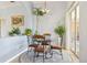 Cozy dining area featuring a chandelier, round table with four chairs, and an abundance of indoor plants at 10435 Deerberry Dr, Land O Lakes, FL 34638