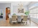 Open dining space featuring large window, chandelier, and elegant furniture at 10435 Deerberry Dr, Land O Lakes, FL 34638