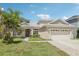 Charming single-story home featuring a two-car garage, landscaped lawn, and inviting curb appeal at 10435 Deerberry Dr, Land O Lakes, FL 34638