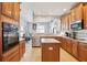 Modern kitchen with stainless steel appliances, wooden cabinets, and open layout at 10435 Deerberry Dr, Land O Lakes, FL 34638