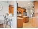 Bright kitchen featuring wood cabinetry, island, and bar seating area at 10435 Deerberry Dr, Land O Lakes, FL 34638