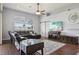 Bright living room with a sectional sofa, wooden floors, a ceiling fan and a sliding barn door at 10435 Deerberry Dr, Land O Lakes, FL 34638
