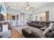 Open-concept living room featuring a sectional sofa, wooden floors, and seamless transition to other spaces at 10435 Deerberry Dr, Land O Lakes, FL 34638